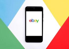 Ebay logo on white screen of smartphone.Ebay app photo