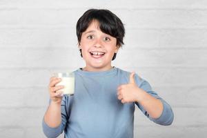 smiling child drinking milk photo