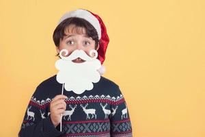 Child Wearing Christmas Santa Claus Hat and beard photo