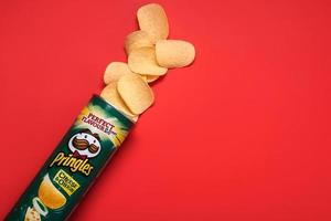 Pringles cheese and onion.Cardboard tube can with Pringles potato chips photo