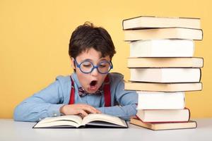 surprised boy reading a book photo