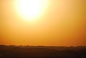 sunset with mountain in the desert photo