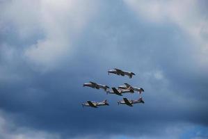 six aircraft flying at a flight show very close to each other photo