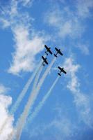 four planes fly high and fast at an air photo