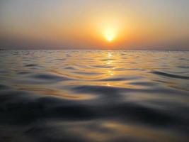 olas suaves en la cálida puesta de sol foto