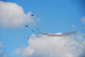 six planes fly apart at an air show in summer with fog photo