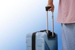 Traveler woman walking carrying a suitcase. photo