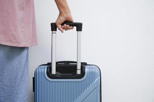 Traveler woman walking carrying a suitcase. photo