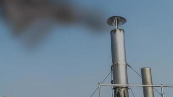 Chimney emitting black smoke. Environmental work. chemicals plant's cooler emitting vapour. photo