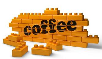 coffee word on yellow brick wall photo