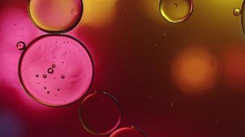 Abstract Colorful Food Oil Drops Bubbles and spheres Flowing on Water Surface, macro Videography video