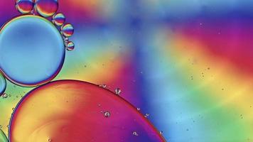 Abstract Colorful Food Oil Drops Bubbles and spheres Flowing on Water Surface, macro Videography video