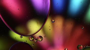 Abstract Colorful Food Oil Drops Bubbles and spheres Flowing on Water Surface, macro Videography video