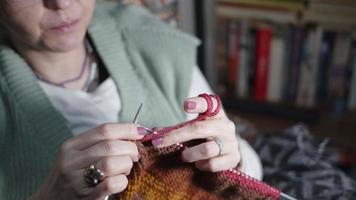 Young Woman Knits with Colorful balls of Wool and Needles video