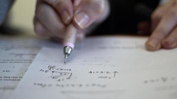 Studying Physics with Pencil on White Paper video