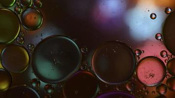 Abstract Colorful Food Oil Drops Bubbles and spheres Flowing on Water Surface, macro Videography video