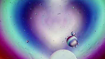 Abstract Colorful Food Oil Drops Bubbles and spheres Flowing on Water Surface, macro Videography video