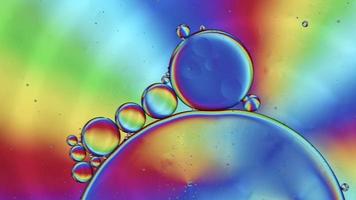 Abstract Colorful Food Oil Drops Bubbles and spheres Flowing on Water Surface, macro Videography video