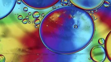 Abstract Colorful Food Oil Drops Bubbles and spheres Flowing on Water Surface, macro Videography video