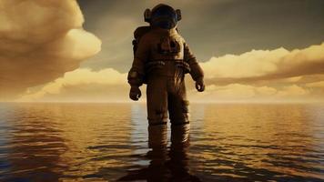 Spaceman in the sea under clouds at sunset video