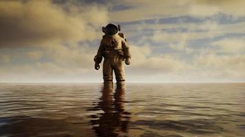 Spaceman in the sea under clouds at sunset video