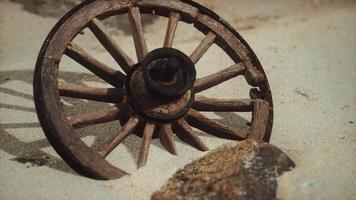 Large wooden wheel in the sand video