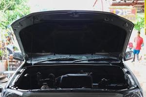 The car opened the bonnet to repair the engine. photo