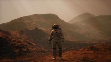 Spaceman walks on the red planet Mars. Space Mission video