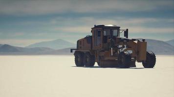 road grading machine on the salt desert road video