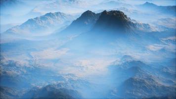 Distant mountain range and thin layer of fog on the valleys video