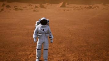 Astronaut on Mars Surface. Red Planet Covered in Gas and rock video