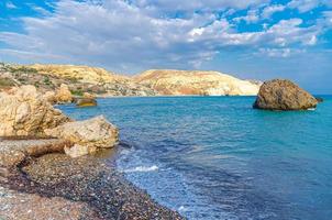 Aphrodite Beach with Stone Rocks in Aphrodite bay of Mediterranean sea water photo