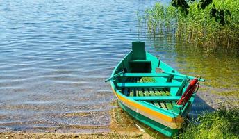 Colourful green fishing boat with paddles photo