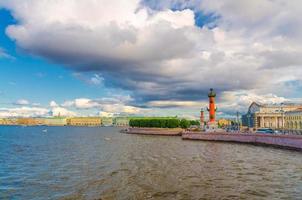 Strelka Arrow of Vasilyevsky Island with green trees and Rostral Columns, colorful buildings photo