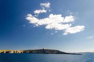 Tower bastioned on island Comino in Mediterranean Sea, Malta photo