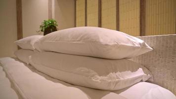 white pillows decoration on bed in luxury hotel resort bedroom video