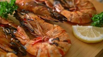 grilled tiger prawns or shrimps with lemon on wood board video