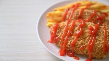 fried chicken breast fillet steak with French fries and ketchup