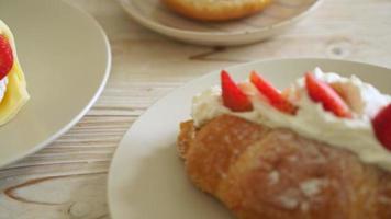 strawberry and fresh cream croissant on plate video