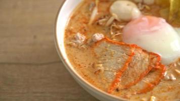 Rice vermicelli noodles with meatball, roasted pork and egg in spicy soup - Tom Yum Noodles video