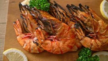 grilled tiger prawns or shrimps with lemon on wood board video