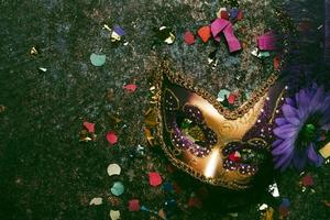 Venetian carnival mask and party confetti with copy space. Carnival celebration concept photo