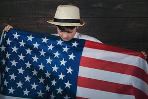 sad child with the flag of the United States photo