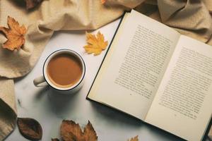 Top view of book and cup of coffee. Selective focus photo