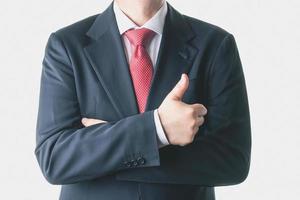 Businessman with thumbs up gesture photo