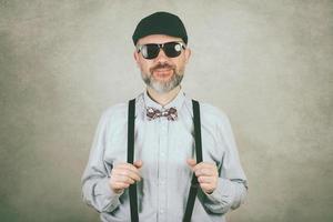 happy man with sunglasses and bow tie photo