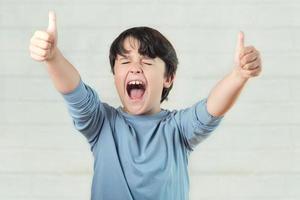 euphoric child showing thumbs up photo