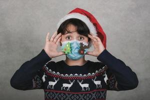 Merry Christmas,kid with funny christmas medical mask photo