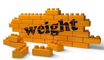 weight word on yellow brick wall photo