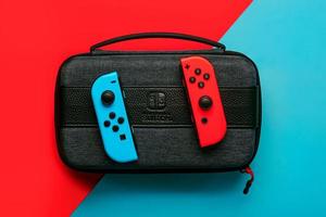 Nintendo Switch video game console with Nintendo two Joy-Cons and Nintendo switch bag photo